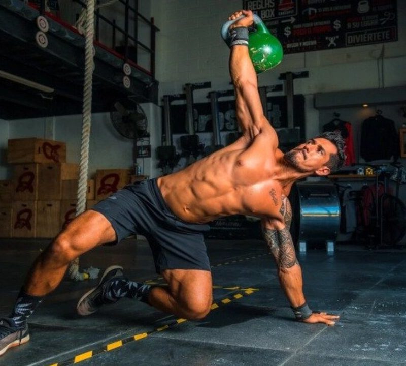 Man doing ab exercise with kettlebell.