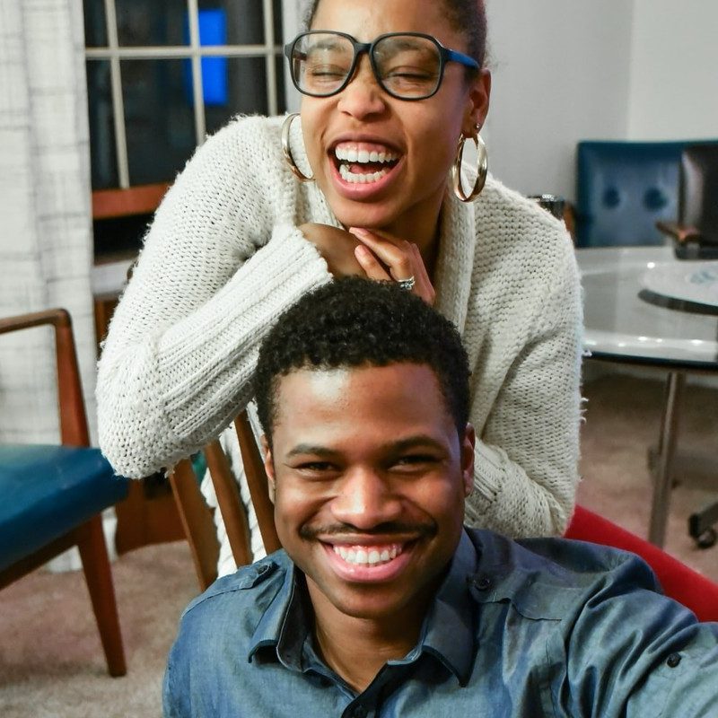 A man and woman smilng.