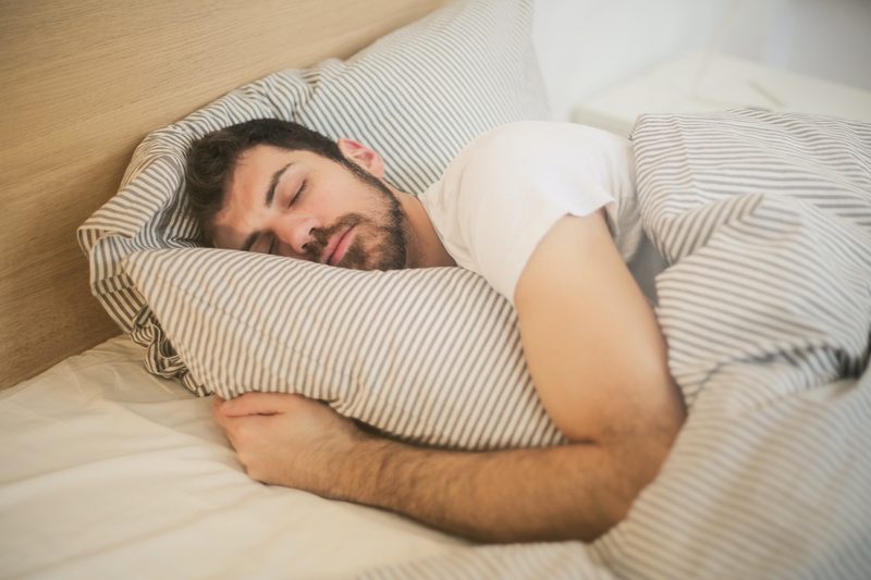 A man on his side sleeping.