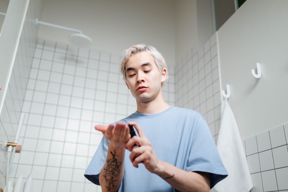 man applying a skincare product after showering