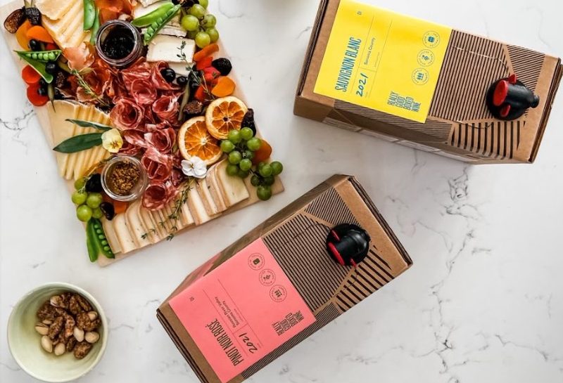 Really Good Boxed Wine on the table with snacks.