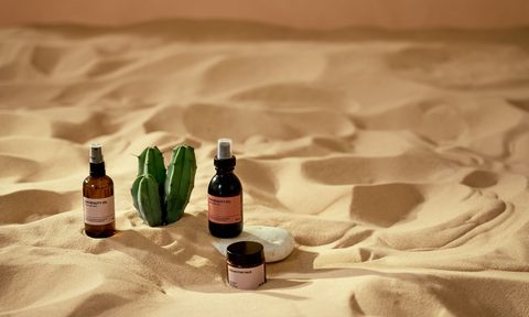 skincare products in the sand