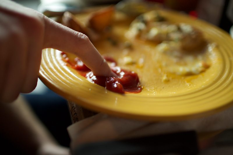 Finger dipped in ketchup