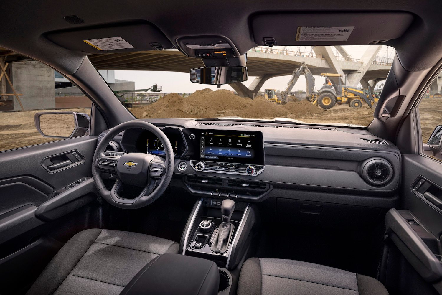 2023 Chevrolet Colorado Interior of the WT trim at a job site with dirt in the back.