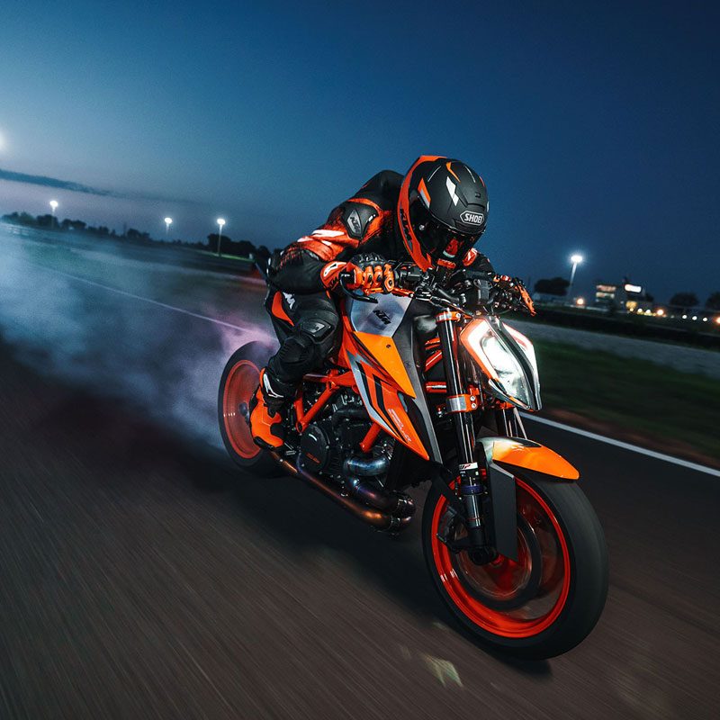 Man riding a 2023 KTM 1290 Super Duke R EVO motard-style motorcycle.