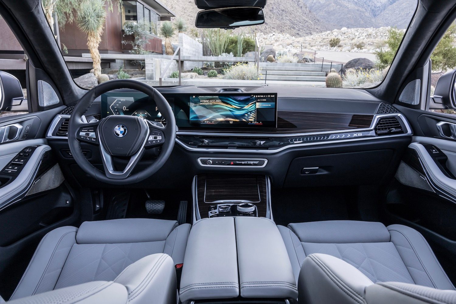 Close up of front dashboard and steering wheel in the 2024 BMW X5 and X6 from the rear seats.