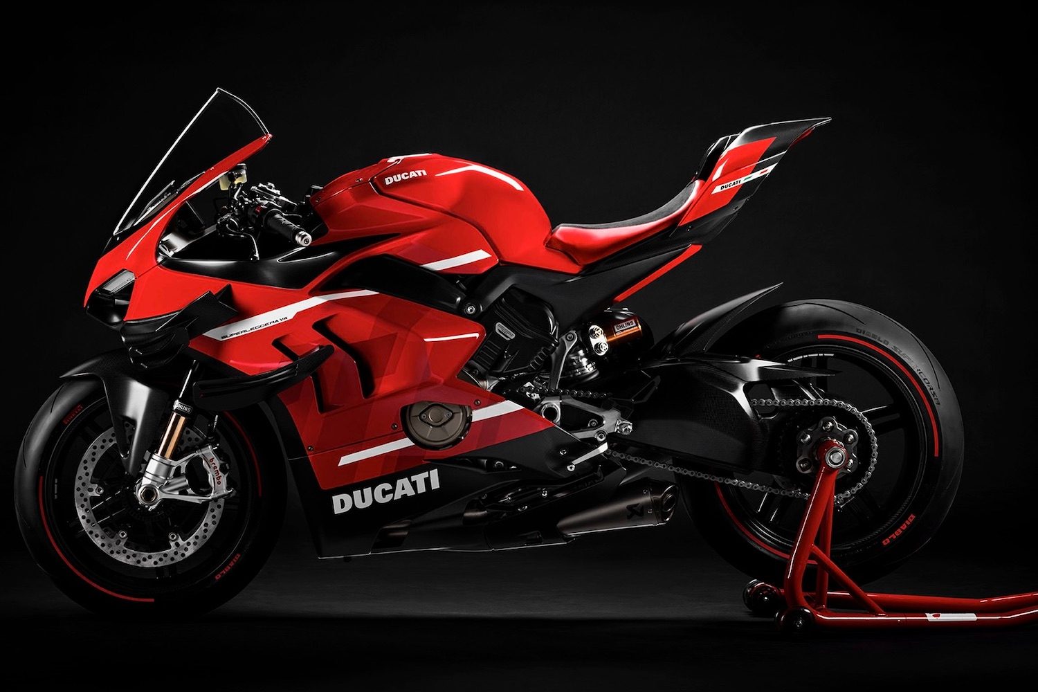 Ducati Superleggera V4 side profile with a rear stand in front of a black screen.