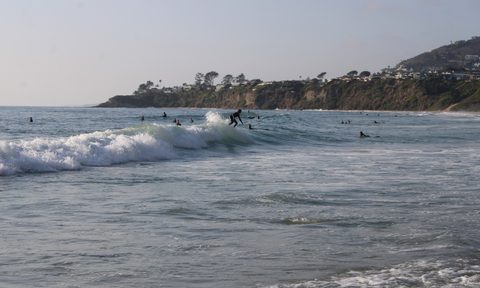 A surfer rides a wave at Salt Creek Beach in Dana Point, California.