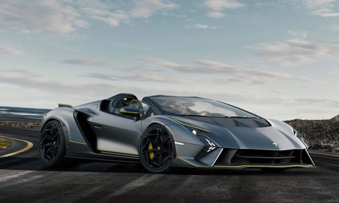 Lamborghini Auténtica front end angle parked in the middle of a windy road with clouds in the back.