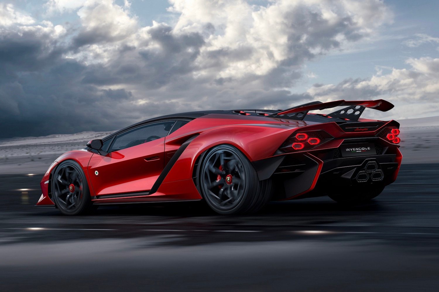 Rear end angle of Lamborghini Invencible parked on damp tarmac with dark clouds in the back.