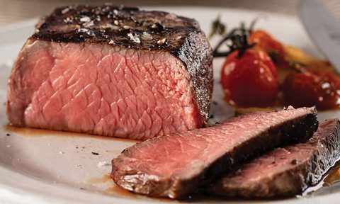 Omaha Steaks butcher's cut filet mignon closeup sliced on a plate.