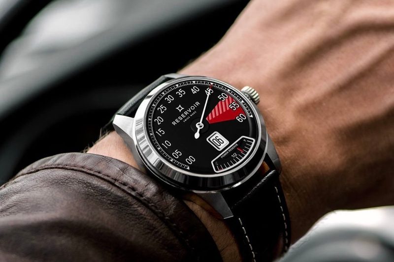 Reservoir Supercharged Sport Red Zone on a man's wrist next to a leather jacket in a classic car.