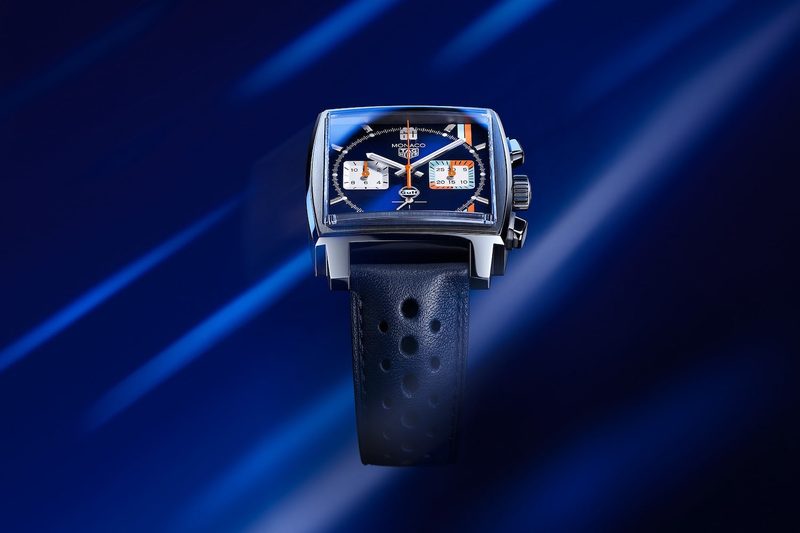 Tag Heuer Monaco X Gulf floating in a blue screen with lines in the back.