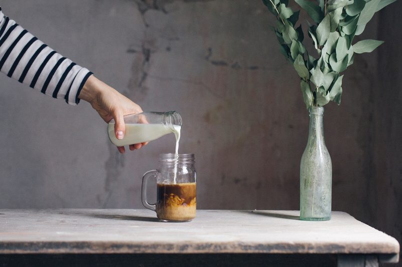 Cream being poured into coffee