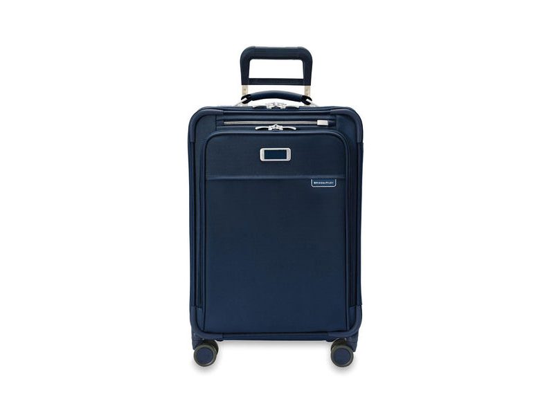 Briggs & Riley Baseline Essential Carry-On Expandable Spinner (in navy) on a white studio background.