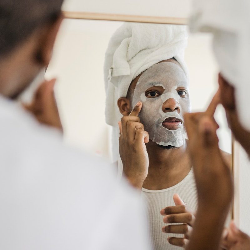 Man with mask looking into the mirror