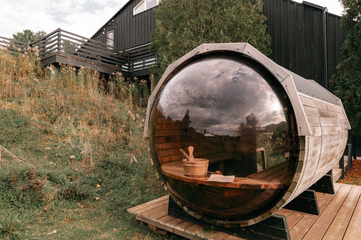 a barrel sauna with a glass window
