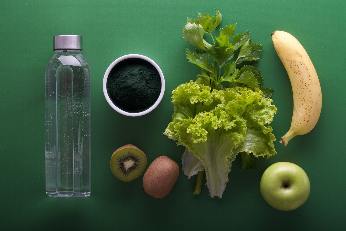 a produce flatlay on a green background
