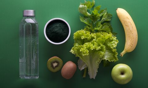 a produce flatlay on a green background