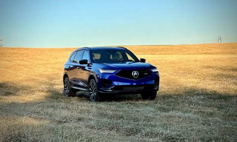 2022 Acura MDX Type S front end angle from the passenger's side in a hay field with blue skies in the back.