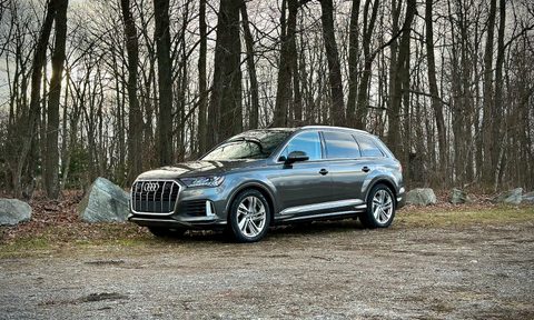 Front end angle of the 2022 Audi Q7 Prestige from the side in front of trees.