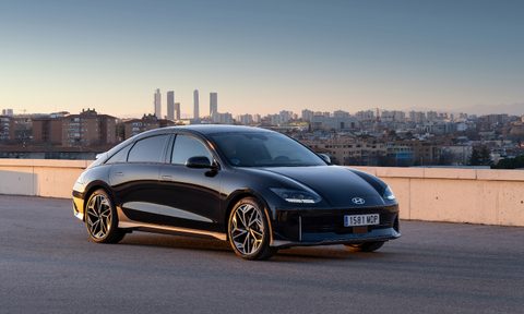 2023 Hyundai Ioniq 6 front end angle from passenger's side with a city in the back.