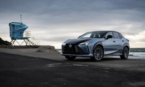 2023 Lexus RZ 450e front end angle from driver's side parked in front of a beach.