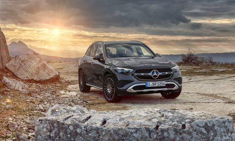 2023 Mercedes-Benz GLC front end angle from passenger's side parked in front of mountains during sunset.