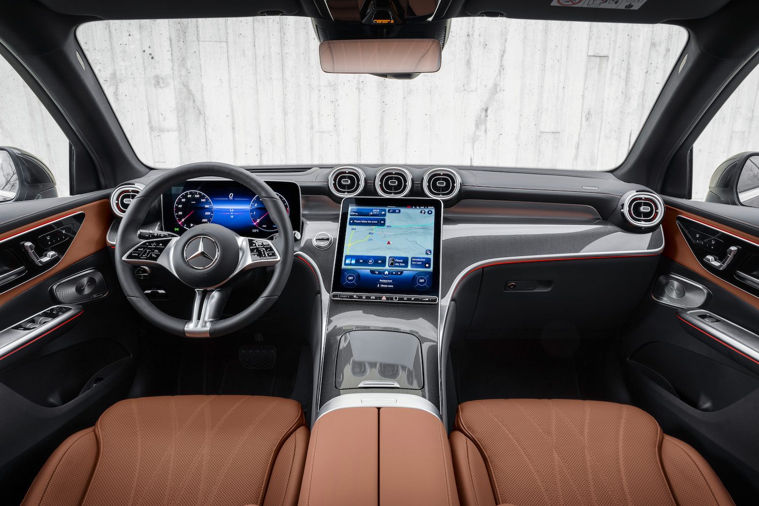 2023 Mercedes-Benz GLC close up of dashboard and steering wheel in front of a white wall.