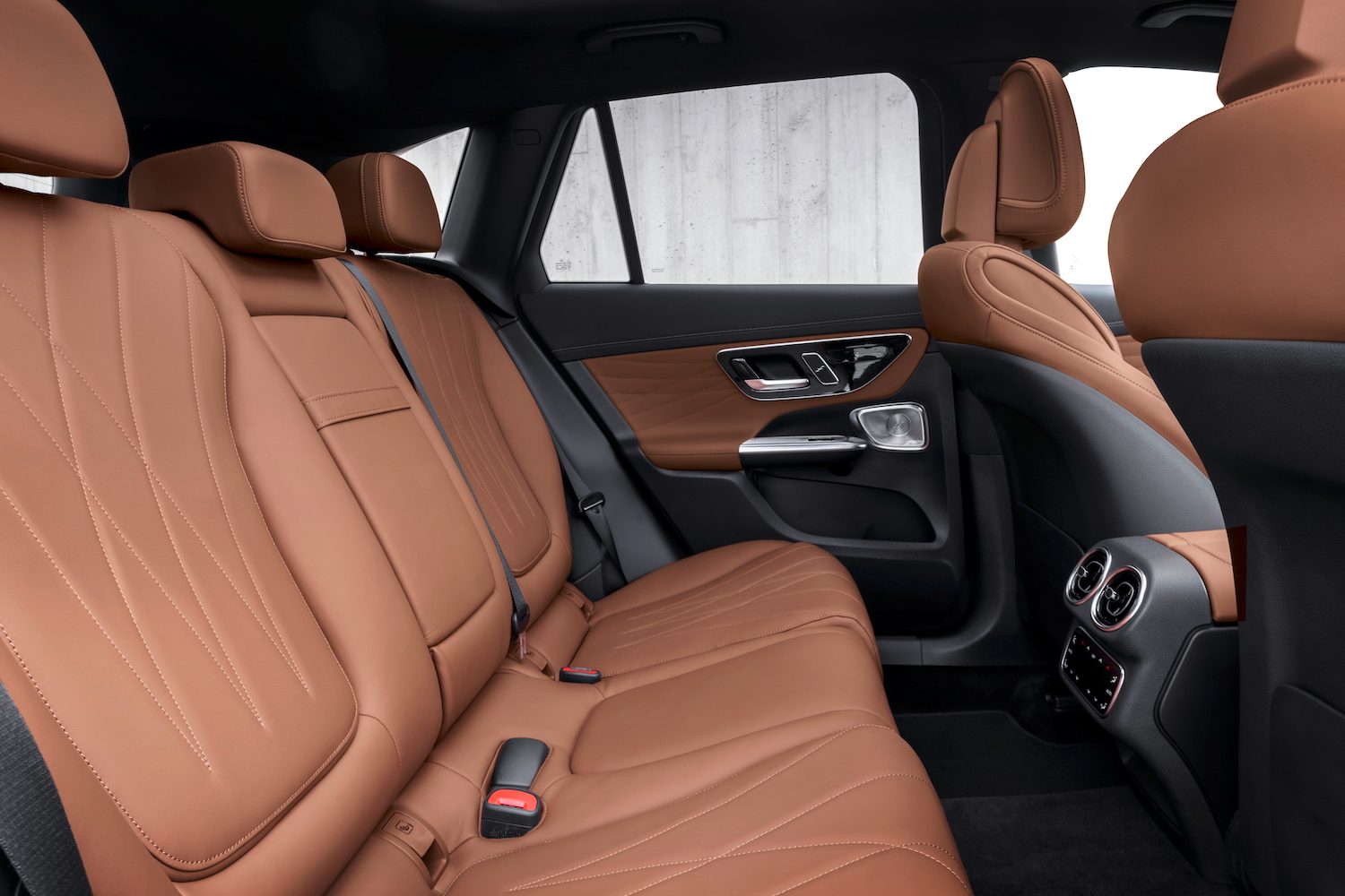 Rear seats in the 2023 Mercedes-Benz GLC parked in front of a white wall.