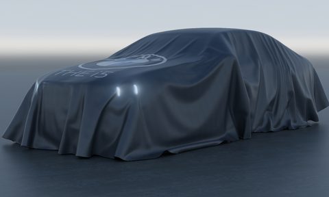 BMW i5 electric sedan under a cover parked in a studio.