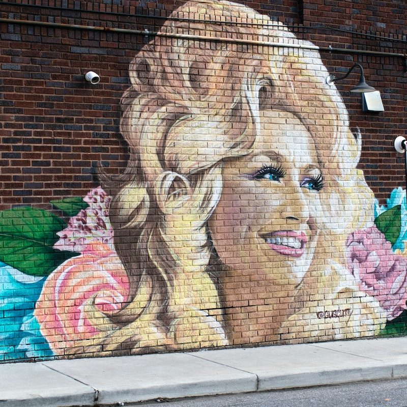 Dolly Parton mural painted on a brick wall