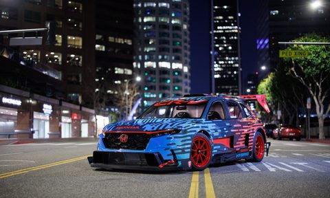 Honda CR-V Hybrid Racer front end angle from driver's side parked in the middle of a road at night.