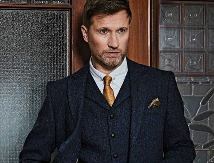 Man in suit and gold tie