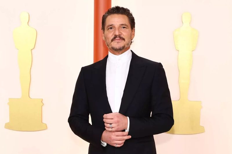 Pedro Pascal wearing white high-collar shirt and black tuxedo at the Oscars