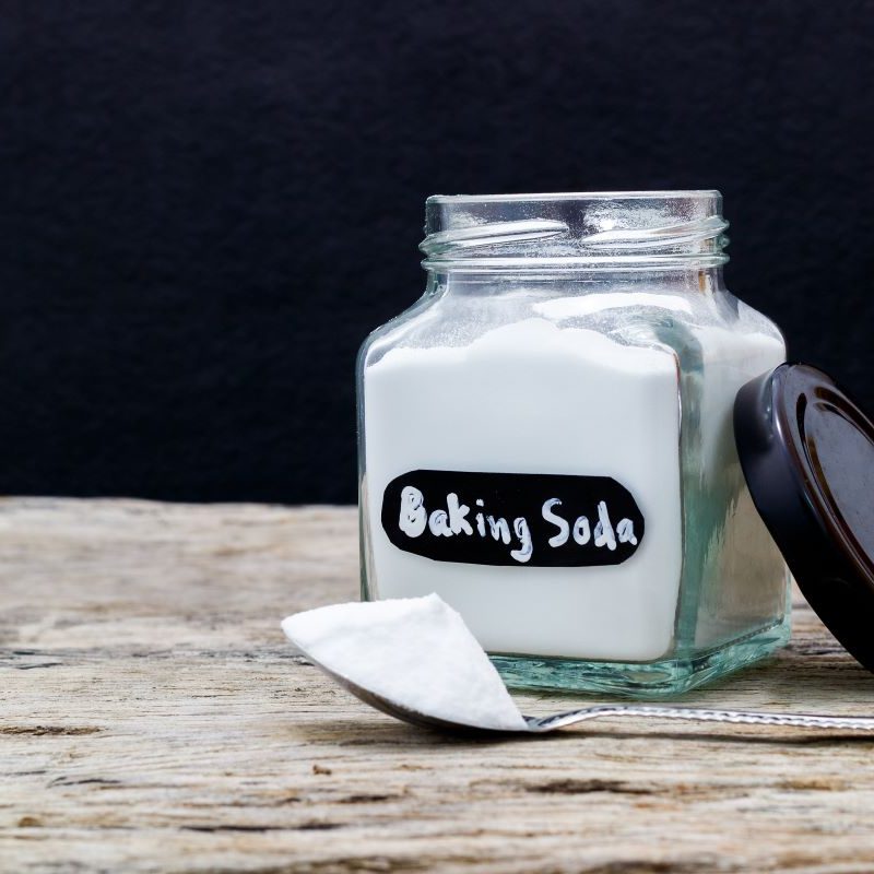 Container of baking soda for cleaning headlights