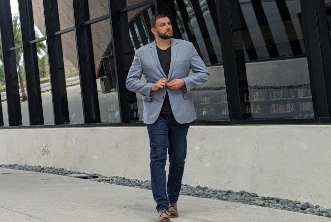 Man in dark dress denim and blue sport coat