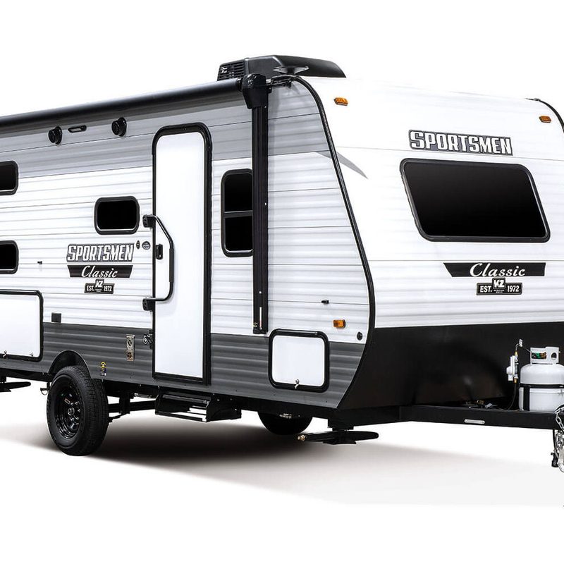 KZ RV Sportsmen Classic 130RB lightweight travel trailer on a plain, white studio background.