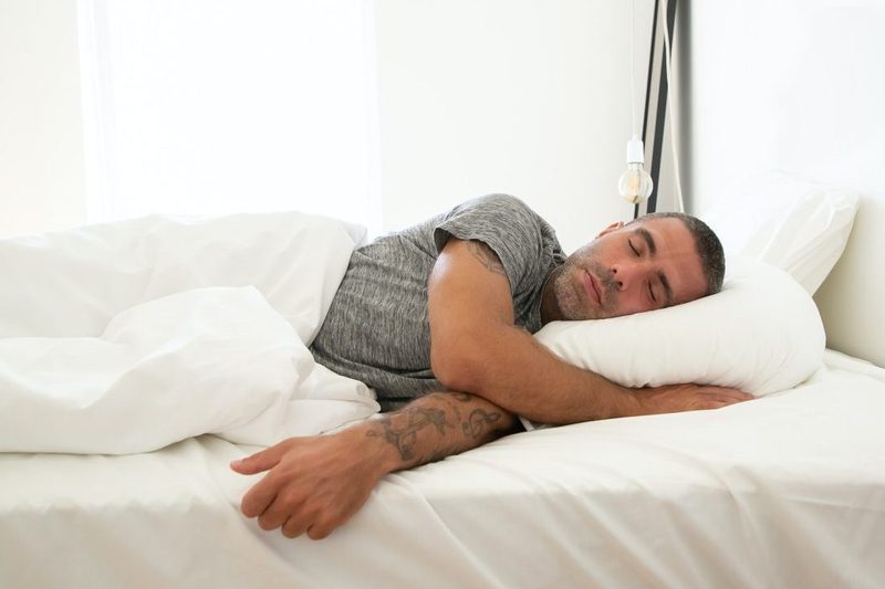 A man asleep in bed.