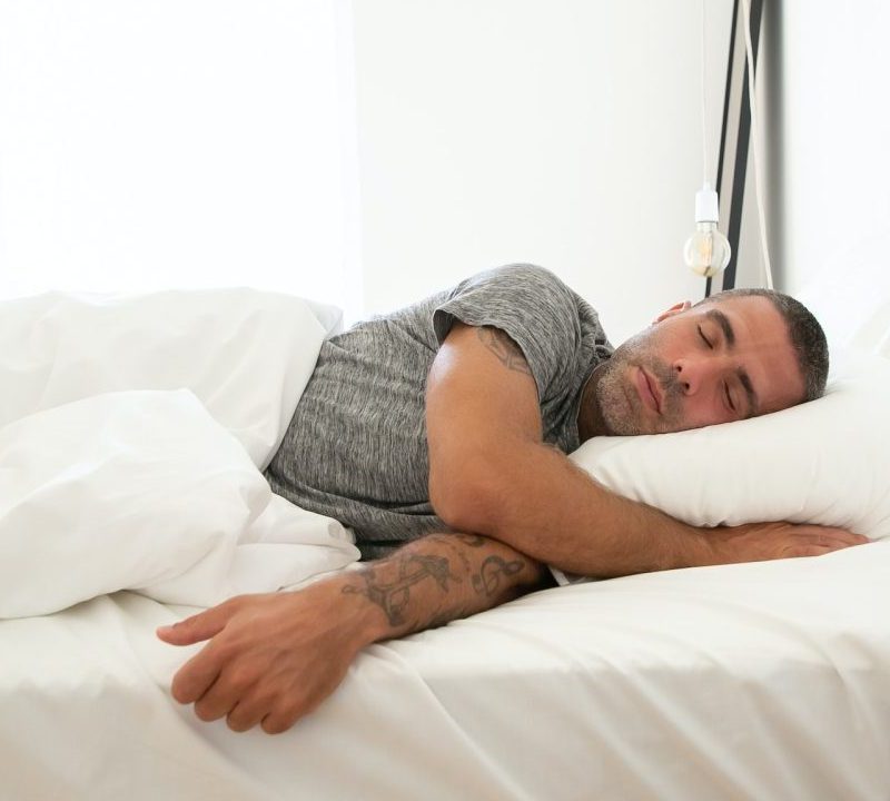 A man asleep in bed.