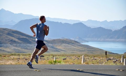 man running by mountain