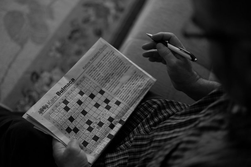 A person doing a crossword puzzle.