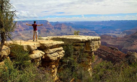 A person on top of the canyon enjoying the view