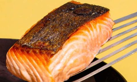 A close-up view of a thick, seared salmon filet