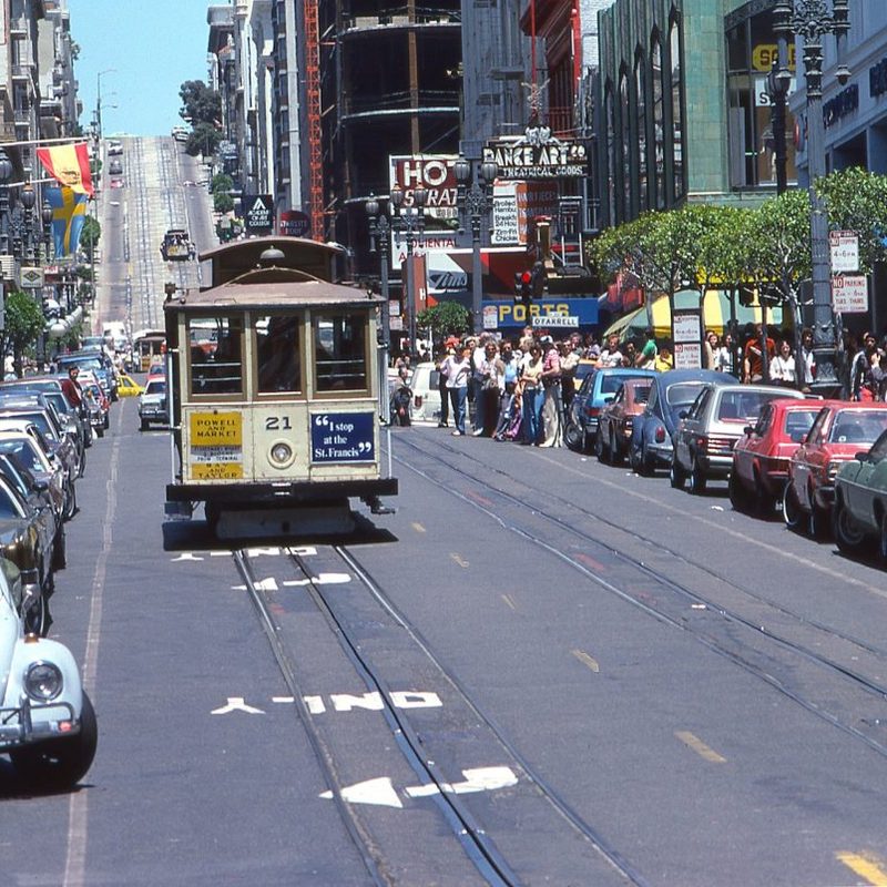 A busy street with a trolly going down it