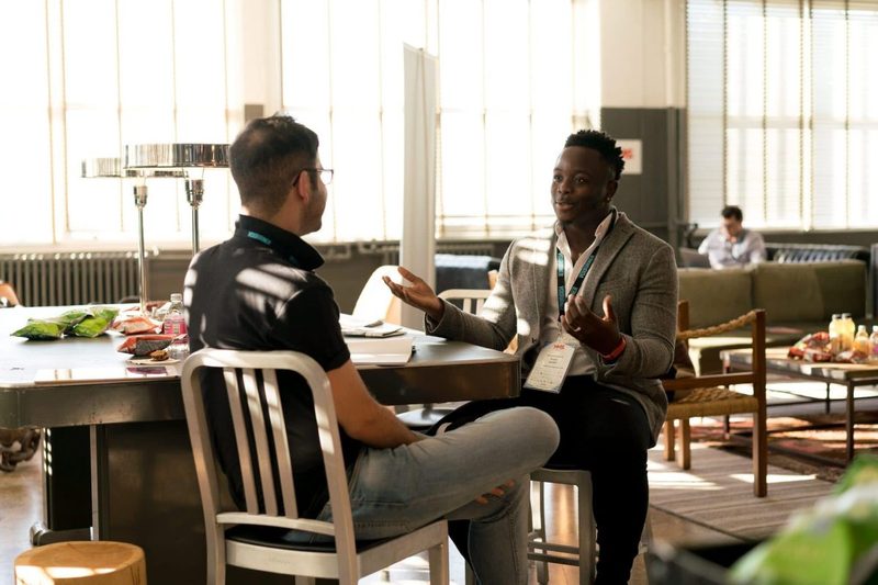 Two people having a quick work meeting while sitting down.
