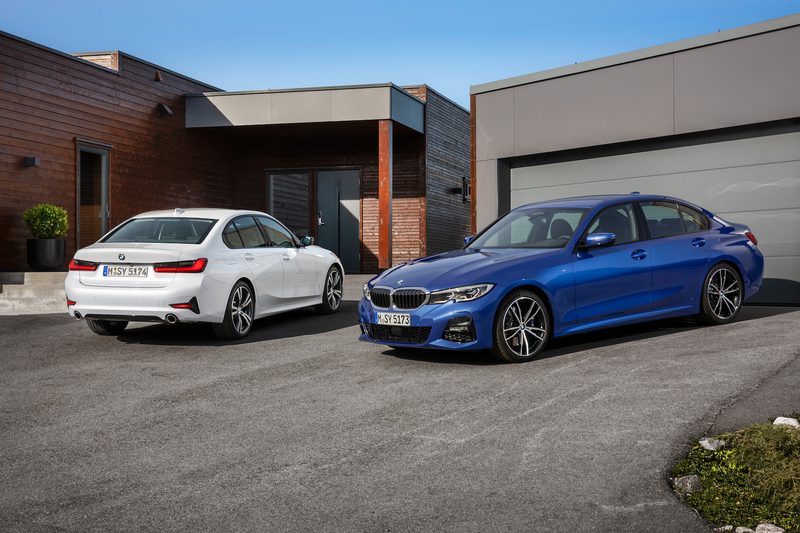 2019 BMW 3-Series front end and rear end angle parked on a driveway in front of a house.