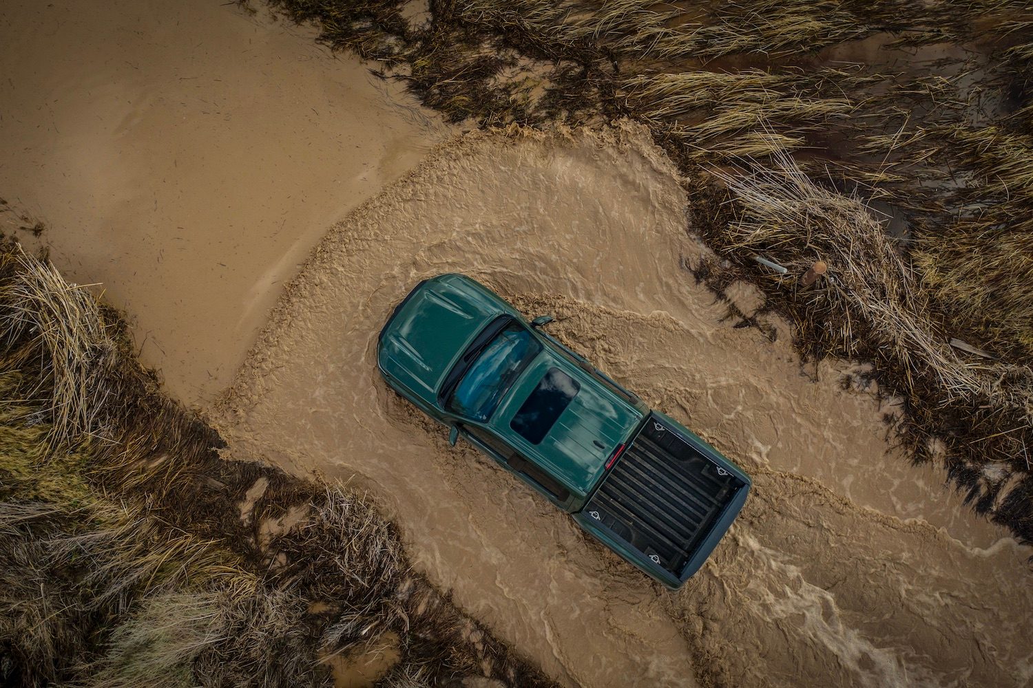 Overhead photo of the 2022 Nissan Frontier Pro-4X fording through deep water in the desert.