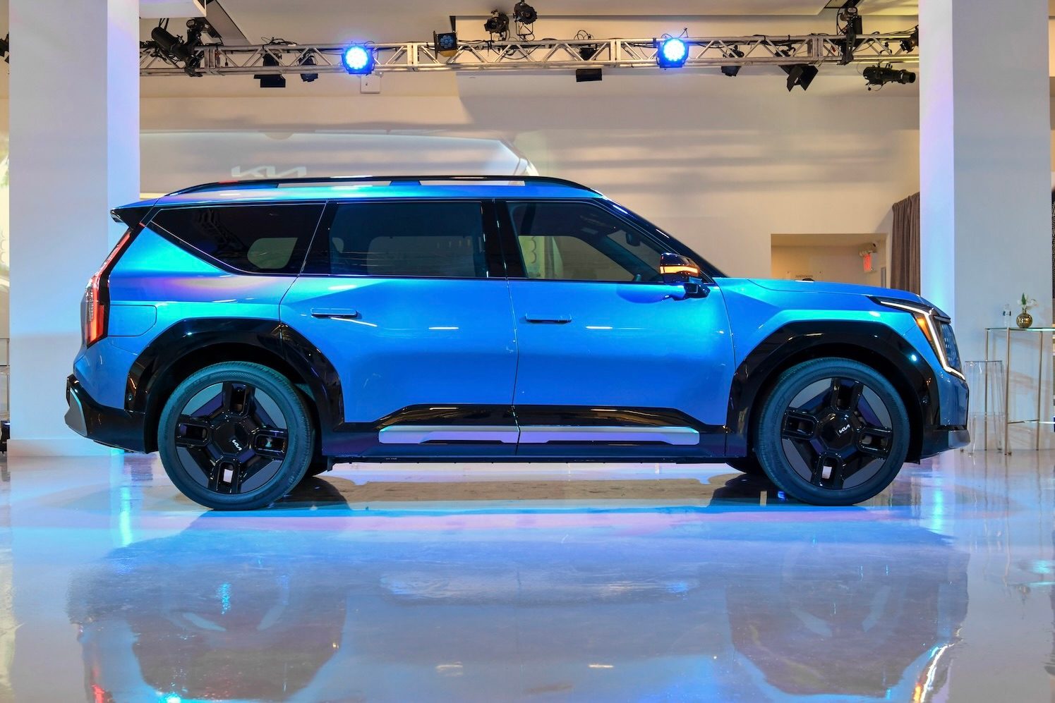 Side profile of the 2024 Kia EV9 parked in a studio.