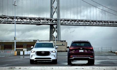 2024 Mazda CX-90 PHEV and Turbo S parked in front of a bridge from rear end and front end.